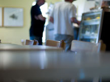 The cafe counter and pastry case seen across a table
